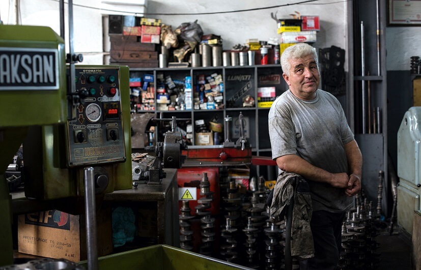 man in a motorcycle repair shop